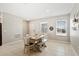 Bright dining room with tile flooring and a dining table set with 4 chairs and a bench at 15287 Aquarius Way, Mascotte, FL 34753