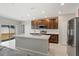 Modern kitchen featuring a large center island, stainless steel appliances and tile flooring at 15287 Aquarius Way, Mascotte, FL 34753