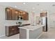 Stylish kitchen with dark cabinets, stainless steel appliances, and a center island at 15287 Aquarius Way, Mascotte, FL 34753