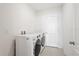 Bright laundry room equipped with modern washer and dryer units and plenty of space at 15287 Aquarius Way, Mascotte, FL 34753