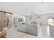Spacious living room with sliding barn door access to bedroom and comfortable seating at 15287 Aquarius Way, Mascotte, FL 34753
