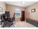 Cozy office space features a modern desk and chair, as well as ample natural light at 15287 Aquarius Way, Mascotte, FL 34753