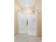 Modern shower features tiled walls, sliding glass door, and ample storage at 15287 Aquarius Way, Mascotte, FL 34753
