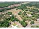 Gorgeous aerial view of property with lush trees, a detached garage and long driveway at 155 W C-466, Lot # 1 W C 466, Oxford, FL 34484