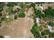 An aerial shot of a house with trees in the yard, near a barn and a long driveway at 155 W C-466, Lot # 1 W C 466, Oxford, FL 34484