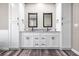 Elegant bathroom featuring double sinks with granite countertops and shaker cabinets at 155 W C-466, Lot # 1 W C 466, Oxford, FL 34484