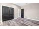 Bedroom with wood-look flooring and a black double door entrance to closet at 155 W C-466, Lot # 1 W C 466, Oxford, FL 34484