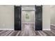 This bedroom features wood-look floors and a black sliding door closet at 155 W C-466, Lot # 1 W C 466, Oxford, FL 34484