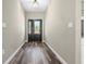 Light-filled foyer with wood-look flooring and a decorative front door that welcomes you inside at 155 W C-466, Lot # 1 W C 466, Oxford, FL 34484