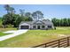 Charming single-story home featuring a well-manicured lawn, an attached garage, and a welcoming front porch at 155 W C-466, Lot # 1 W C 466, Oxford, FL 34484