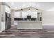 Modern kitchen with white cabinets, granite countertops, stainless steel appliances, and an island at 155 W C-466, Lot # 1 W C 466, Oxford, FL 34484