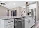 Close-up of kitchen island, granite countertops, stainless steel appliances, and white cabinets at 155 W C-466, Lot # 1 W C 466, Oxford, FL 34484