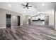 Open living space with wood-look flooring, a sliding barn door, and modern kitchen at 155 W C-466, Lot # 1 W C 466, Oxford, FL 34484
