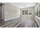 Bright living room with large windows offering beautiful views, and wood-look flooring at 155 W C-466, Lot # 1 W C 466, Oxford, FL 34484