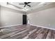 Spacious main bedroom with wood-look floors and a door leading to the bathroom at 155 W C-466, Lot # 1 W C 466, Oxford, FL 34484