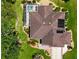 Aerial view of the home showing the roof, pool, solar panels, and landscaped yard at 17194 Se 85Th Willowick Cir, The Villages, FL 32162
