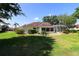 Expansive backyard featuring a screened-in porch and ample green space, ideal for outdoor relaxation and entertainment at 17194 Se 85Th Willowick Cir, The Villages, FL 32162