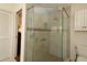 Modern bathroom features a glass-enclosed shower with tile surround, handheld sprayer and shower seat at 17194 Se 85Th Willowick Cir, The Villages, FL 32162