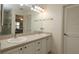 Bathroom featuring double sinks, lots of counter space, and a large mirror for convenience at 17194 Se 85Th Willowick Cir, The Villages, FL 32162