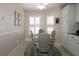 Cozy dining area featuring a stylish table, chairs, and ample natural light from shuttered windows at 17194 Se 85Th Willowick Cir, The Villages, FL 32162