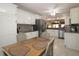 Open-concept kitchen and dining area features stylish furniture, flooring and stainless appliances at 17194 Se 85Th Willowick Cir, The Villages, FL 32162