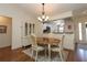 Cozy dining room with elegant chandelier and adjacent kitchen view at 17194 Se 85Th Willowick Cir, The Villages, FL 32162