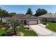 Beautiful home with a three-car garage, manicured lawn, and patterned driveway at 17194 Se 85Th Willowick Cir, The Villages, FL 32162