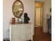 Elegant foyer featuring a stylish console table with decorative items and an oval mirror at 17194 Se 85Th Willowick Cir, The Villages, FL 32162