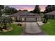 Beautiful single-story home boasts a three-car garage and an inviting, well-manicured front lawn at 17194 Se 85Th Willowick Cir, The Villages, FL 32162