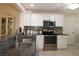 Well-lit kitchen featuring stainless appliances, granite countertops, and a stylish mosaic backsplash at 17194 Se 85Th Willowick Cir, The Villages, FL 32162