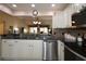 Bright kitchen boasts granite countertops, stainless steel dishwasher, and views into the adjacent living area at 17194 Se 85Th Willowick Cir, The Villages, FL 32162
