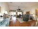 Inviting living room with wood floors, vaulted ceilings, and comfortable seating area at 17194 Se 85Th Willowick Cir, The Villages, FL 32162