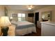 Inviting main bedroom with comfortable bedding, dresser, and plenty of natural light at 17194 Se 85Th Willowick Cir, The Villages, FL 32162