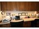 Built-in desk and wall decorations in this home office with a black office chair at 17194 Se 85Th Willowick Cir, The Villages, FL 32162
