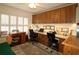 Bright office featuring built-in desks, shelving, storage, and large window with blinds at 17194 Se 85Th Willowick Cir, The Villages, FL 32162