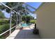 View of screen enclosed pool and spa, featuring lovely landscaping and a view of the golf course at 17194 Se 85Th Willowick Cir, The Villages, FL 32162