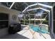 Enclosed pool features a spa and outdoor grill area, perfect for entertaining and relaxation at 17194 Se 85Th Willowick Cir, The Villages, FL 32162