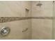 Bright shower featuring neutral tile, a built-in niche, and a chrome rainfall shower head at 17194 Se 85Th Willowick Cir, The Villages, FL 32162