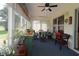 Well lit sunroom with ample seating and backyard views at 17194 Se 85Th Willowick Cir, The Villages, FL 32162