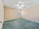 Bright bedroom with carpet, window with shutters, and ceiling fan for comfort at 17427 Se 72Nd Overbrook Ct, The Villages, FL 32162