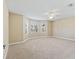 Spacious bedroom with neutral carpet, large windows, and a ceiling fan for comfort at 17427 Se 72Nd Overbrook Ct, The Villages, FL 32162