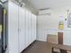 Spacious garage featuring ample white storage cabinets and a modern mini-split AC system at 17427 Se 72Nd Overbrook Ct, The Villages, FL 32162