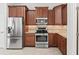 Kitchen with stainless steel appliances, granite countertops and beautiful wood cabinets at 17427 Se 72Nd Overbrook Ct, The Villages, FL 32162