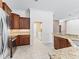 Kitchen with stainless steel appliances, granite countertops and wood cabinets, and access to laundry room at 17427 Se 72Nd Overbrook Ct, The Villages, FL 32162