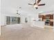 Open living space with a view of the kitchen, bar, and lanai at 17427 Se 72Nd Overbrook Ct, The Villages, FL 32162