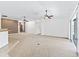 Large living room with tile floors, modern ceiling fans, and access to the outdoor spaces at 17427 Se 72Nd Overbrook Ct, The Villages, FL 32162