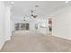 Spacious living area with neutral carpet, ceiling fans, and access to the lanai at 17427 Se 72Nd Overbrook Ct, The Villages, FL 32162
