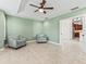 Spacious living room with ceramic tile floors, ceiling fan, and comfortable seating, creating a welcoming atmosphere at 17427 Se 72Nd Overbrook Ct, The Villages, FL 32162