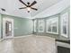 Bright living room featuring tray ceilings, tiled floors, and multiple windows with plantation shutters at 17427 Se 72Nd Overbrook Ct, The Villages, FL 32162