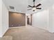 Expansive living room featuring neutral carpeting, ceiling fan, and elegant crown molding at 17427 Se 72Nd Overbrook Ct, The Villages, FL 32162